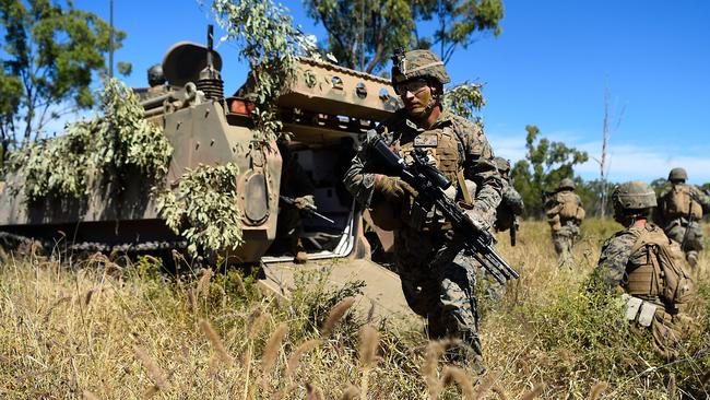 A US Marine disembarks from an armoured personnel carrier during Exercise Southern Jackaroo in Townsville. Photo: Ian Hitchcock / Getty Images