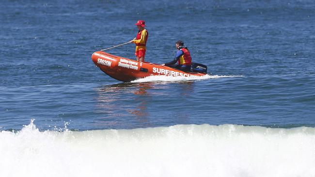 Lifesavers look for the shark at Lighthouse Beach, following the attack. Picture: Jason O'Brien