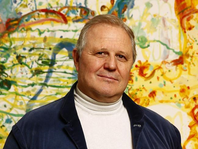 L to R: Tim Olsen in the Olsen Gallery in Woollahra in front of the work "Holiday by the Sea" by Tim's father John Olsen. Picture: John Appleyard