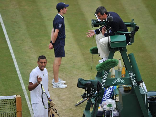 Australia's Nick Kyrgios argues with the umpire about a line call during his men's singles quarter-final match against Canada's Milos Raonic on day nine of the 2014 Wimbledon Championships at The All England Tennis Club in Wimbledon, southwest London, on July 2, 2014. Raonic won 6-7, 6-2, 6-4, 7-6. AFP PHOTO / GLYN KIRK - RESTRICTED TO EDITORIAL USE