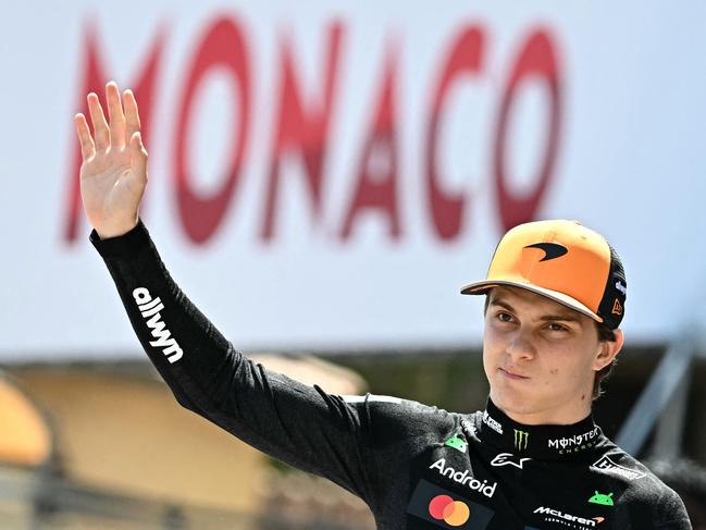 McLaren's Australian driver Oscar Piastri waves as he arrives at the track ahead of the third practice session for the Formula One Monaco Grand Prix at the Circuit de Monaco, on May 24, 2025. (Photo by Gabriel BOUYS / AFP)