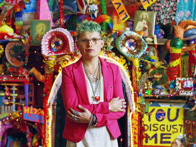 Paul Yore with his kaleidescopic rainbow-coloured sculptural temple constructed of found objects, toys, hand-made tapestry, sequins and more. Picture: MATT THOMPSON