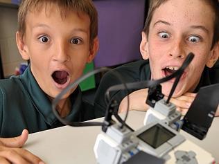 Zachariah Hedrington-Knight and Caleb Schatz watch their robot spin out.