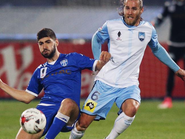 Luke Pavlou of South Melbourne (left) and Josh Brillante of Sydney FC compete for the ball on Wednesday night.
