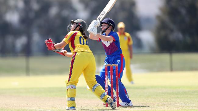 Tahlia Tracy looks on from wicket keeper as Cosette Thomas hits one away for Newcastle. Picture: Sue Graham