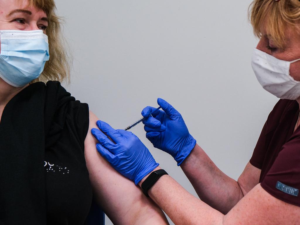 A health worker is given the first jab of Pfizer/BioNTech COVID-19 vaccine by a nurse in Poland. Picture: Omar Marques/Getty Images.