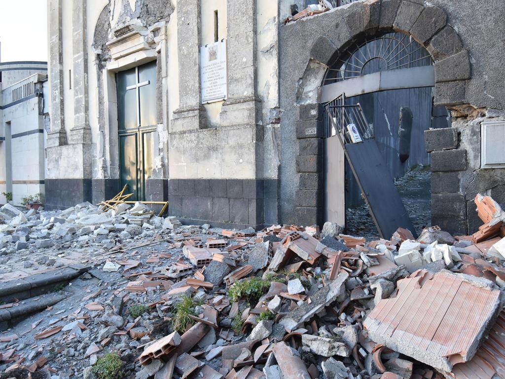 Debris stand in front of the heavily damaged church of Maria Santissima in Fleri, Sicily Italy. Picture: Orietta Scardino/ANSA Via AP