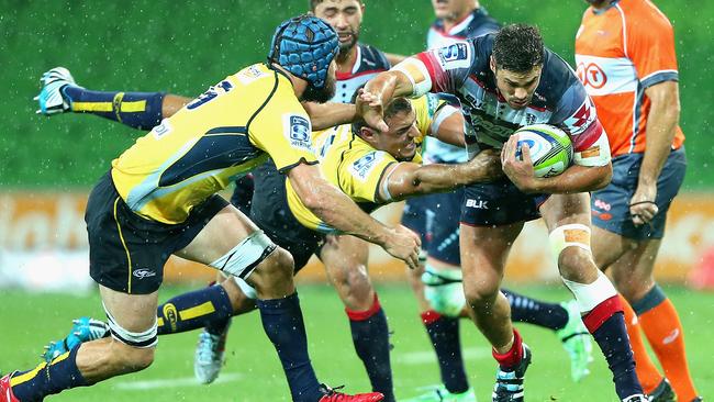 Tom English of the Rebels is tackled.