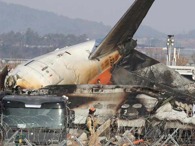 Firefighters check near the wreckage of a passenger plane at Muan International Airport on December 29, 2024 in Muan-gun, South Korea. Picture: Chung Sung-Jun/Getty Images