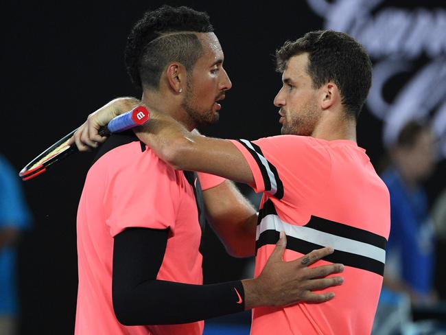 Bulgaria's Grigor Dimitrov (R) speaks with Australia's Nick Kyrgios after winning their men's singles fourth round match on day seven of the Australian Open tennis tournament in Melbourne on January 21, 2018. / AFP PHOTO / SAEED KHAN / -- IMAGE RESTRICTED TO EDITORIAL USE - STRICTLY NO COMMERCIAL USE --
