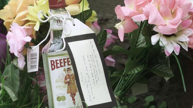 A Beefeater gin bottle with a message attached, joined the floral tributes to Britain's Queen Elizabeth. Picture: Alastair Grant