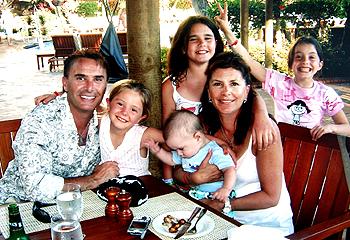 Family holidays: John Ilhan with wife Patricia and children Jaida, Yasmin, Aidan and Hannah in Hawaii in July.