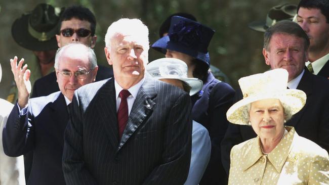 Peter Hollingworth, centre, with Queen Elizabeth II and prime minister John Howard in 2002.