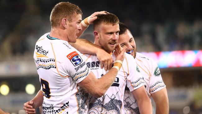 CANBERRA, AUSTRALIA - AUGUST 01: Mack Hansen of the Brumbies is congratulated by team mates after kicking the wiing goal on full time during the round five Super Rugby AU match between the Brumbies and the Reds at GIO Stadium on August 01, 2020 in Canberra, Australia. (Photo by Mark Nolan/Getty Images)