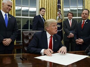 Donald Trump in the Oval Office with some senior advisers.
