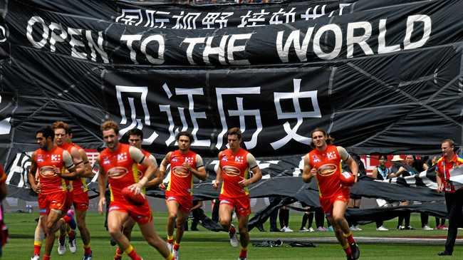 Suns and Port players run on to Jiangwan Stadium, Shanghai on May 14, 2017. Picture: Tracey Nearmy/AAP