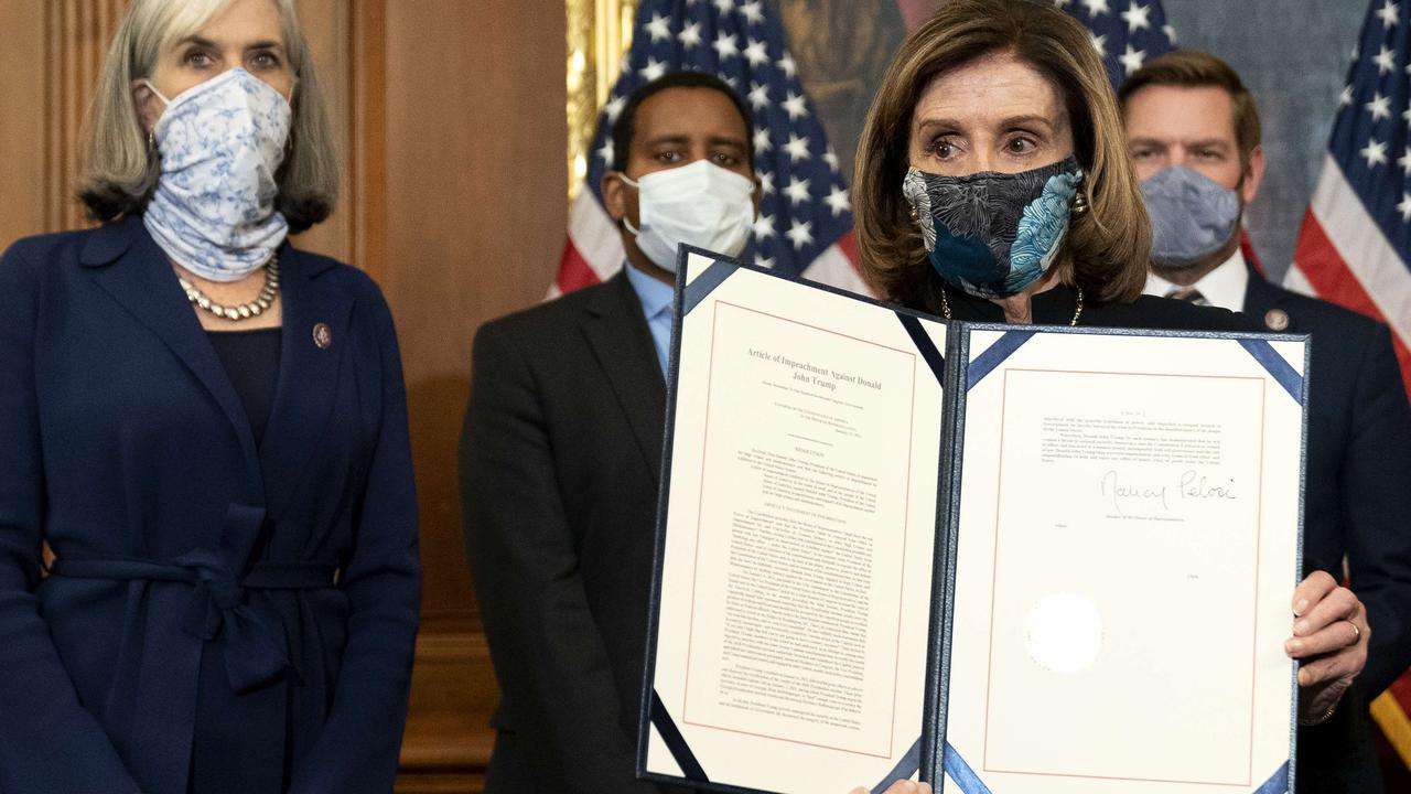 Speaker of the House, Nancy Pelosi, displays a signed article of impeachment against President Donald Trump on January 13, 2021. Picture: Stefani Reynolds/Getty Images/AFP