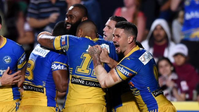 Semi Radradra (centre) of the Eels is congratulated after scoring a try.