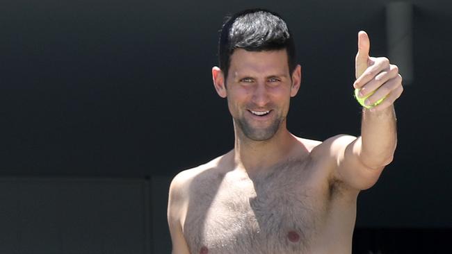 Novak Djokovic is all smiles as he exercises shirtless while in quarantine at the Majestic Suites in North Adelaide. Picture: Dean Martin