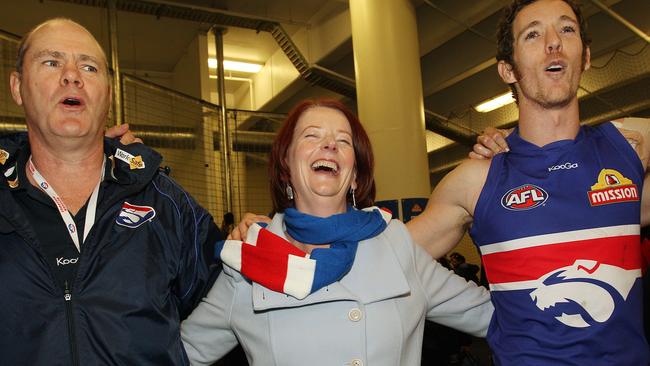 Then Prime Minister and Bulldog fanatic Julia Gillard joins coach Rodney Eade and Robert Murphy in the team song after 71 point win over North Melbourne in round 18.