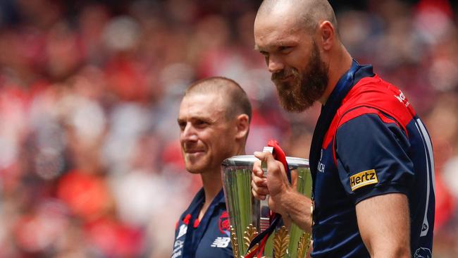 Simon Goodwin and Max Gawn raise the premiership cup at the Melbourne Cricket Ground. Picture: AFL Photos via Getty Images