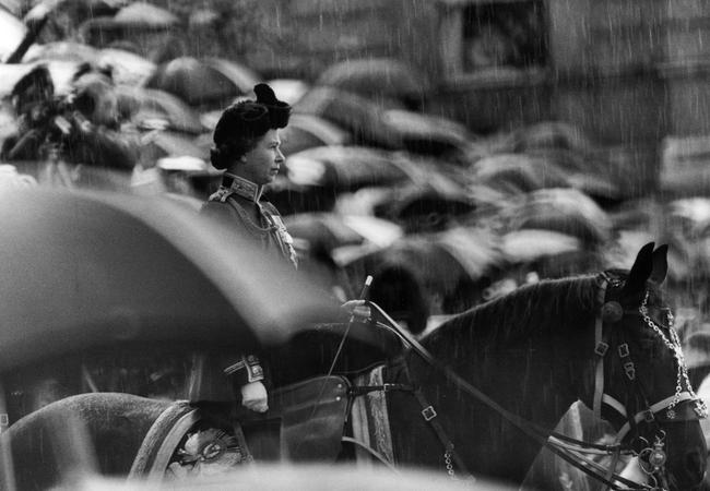 Her Majesty braves the rain in 1977. Picture: Michael Ward/Getty