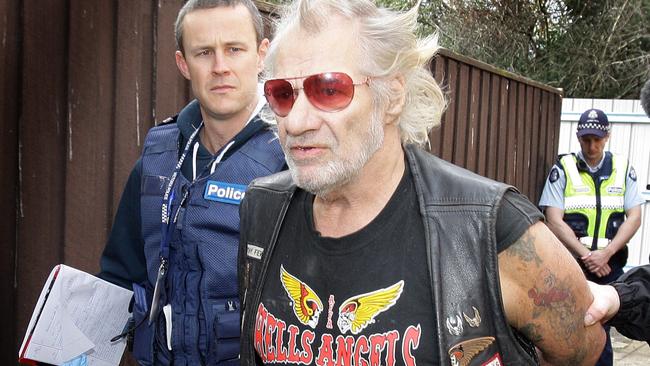 Police lead away “Ball Bearing” after a raid on the Hells Angels' headquarters in Heidelberg.