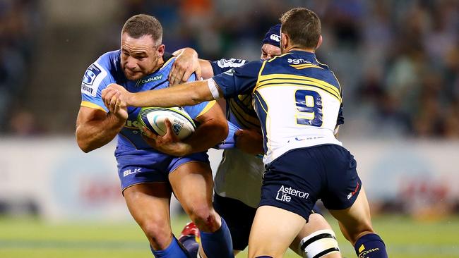 Alby Mathewson of the Force is tackled by the Brumbies’ Nic White.