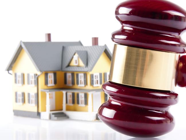 Thinkstock real estate concept on isolated white background. House and auctioneers gavel.