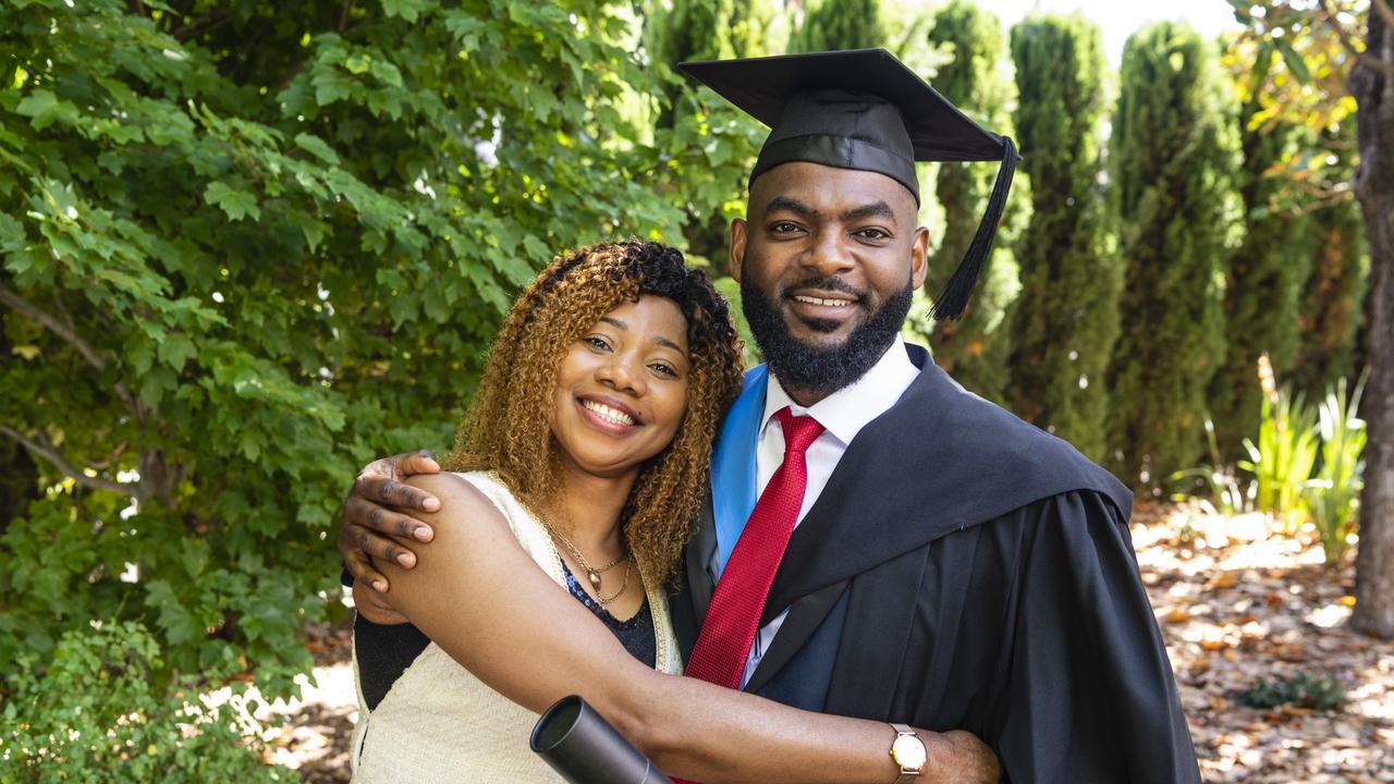 Bachelor of Nursing graduate Ghislain Mutamba celebrates with Labelle Mayangi at the UniSQ graduation ceremony at Empire Theatres, Wednesday, December 14, 2022.