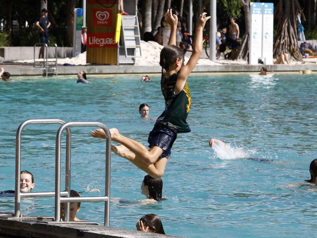 Brisbane residents cooling off at the South Bank beach. Picture: NCA NewsWire/Tertius Pickard