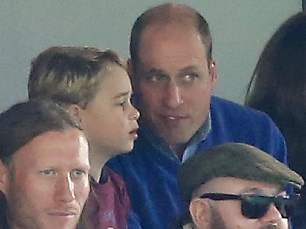 Prince George of Cambridge speaks to Prince William during the Premier League match. Picture: Stephen Pond/Getty Images