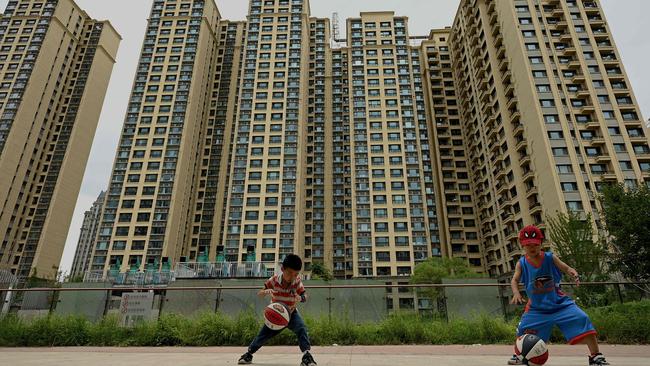 Children playing in Beijing against the backdrop of a Chinese property market under intense pressure. Picture: AFP