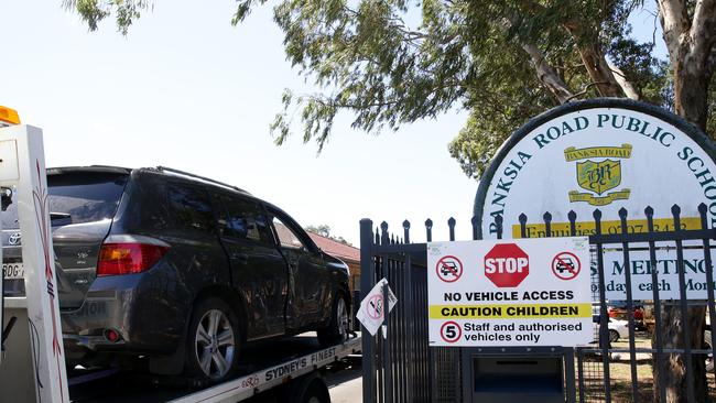 A tow truck removes the Toyota Kluger that ploughed through the side of a Greenacre classroom. Picture: Jonathan Ng