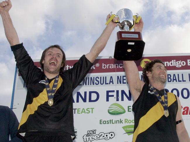 Seaford captain Michael Kraska (left) and coach Anthony Agius lift the 2009 premiership cup.