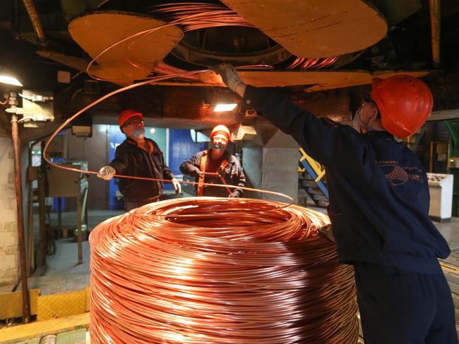 Workers coil copper wire rod following manufacture at a refinery. Photo: Andrey Rudakov/Bloomberg