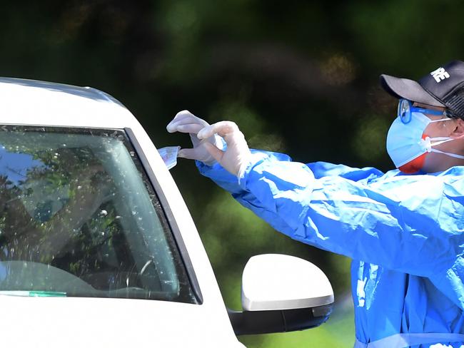 A healthcare worker delivers a test kit. Picture: AFP