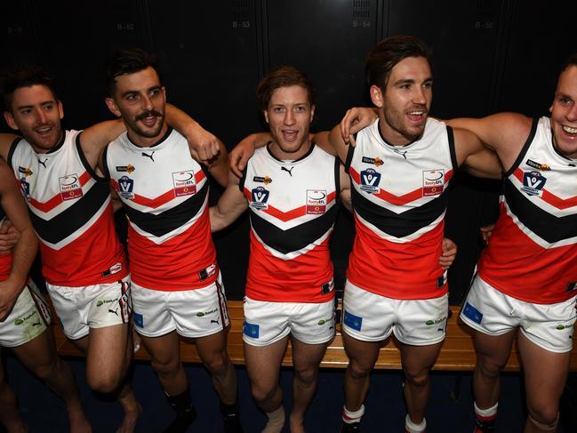 Team members from the Eastern Football team are seen celebrating in the change rooms following their victory in the AFL Community Championships at Etihad Stadium, Melbourne, Sunday, May 19, 2018. Eastern Football League v Geelong Football League. (AAP Image/James Ross) NO ARCHIVING