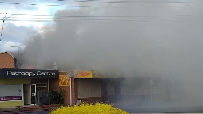 A large volume of smoke was seen coming out of the premises on Tuesday morning. Picture: Supplied