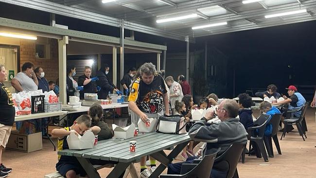 Flood victims and the homeless get dinner at the Loganlea Community Centre.