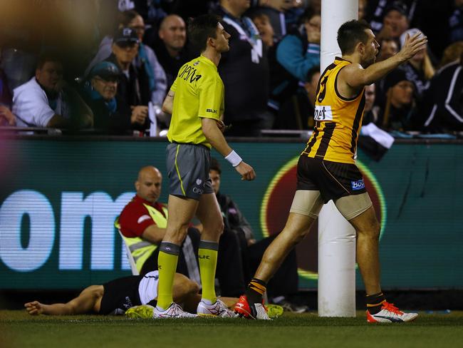 Chad Wingard lies on the ground after copping a high bump from Luke Hodge. Picture: Wayne Ludbey