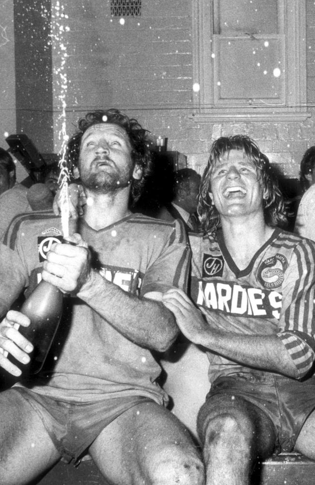 (L-R) Ray Price and Peter Sterling pop a bottle of champagne in the dressing room after Parramatta defeated Newtown in the 1981 grand final at the SCG. Picture: John Burney