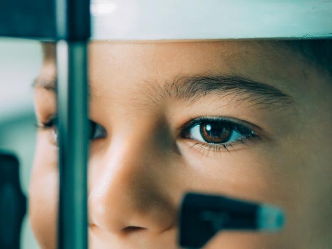 Eye Exam. Ophthalmologist examining boy's eyes with slit lamp Picture: Istock