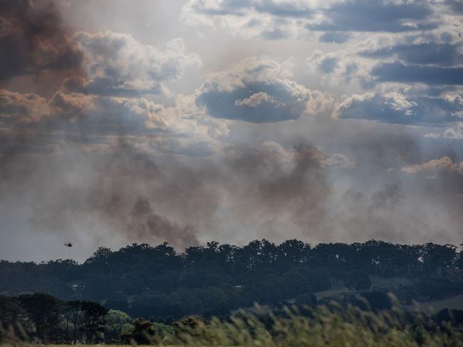 A helicopter battles the blaze, which covered 40ha. Picture: Ian Wilson