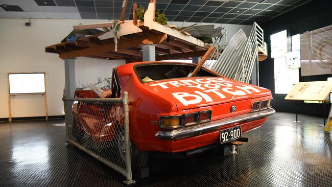 'Tracey You Bitch': Darwin resident John Garner's crushed Holden Torana has been recreated for the Museum and Art Gallery of the Northern Territory's reopened Cyclone Tracy exhibition. Picture: Alex Treacy