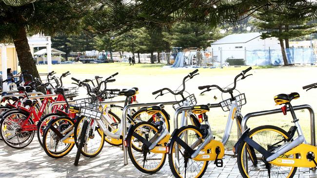 Hire bikes over flow out of a bike rack at Goldstein Reserve at Coogee Beach. Many people are leaving the bikes not at designated bike sites. Picture: John Appleyard