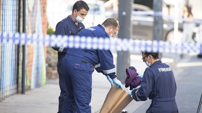 Police collect items of clothing discarded at the scene. Picture: AAP Image/Ellen Smith. Picture: AAP Image/Ellen Smith