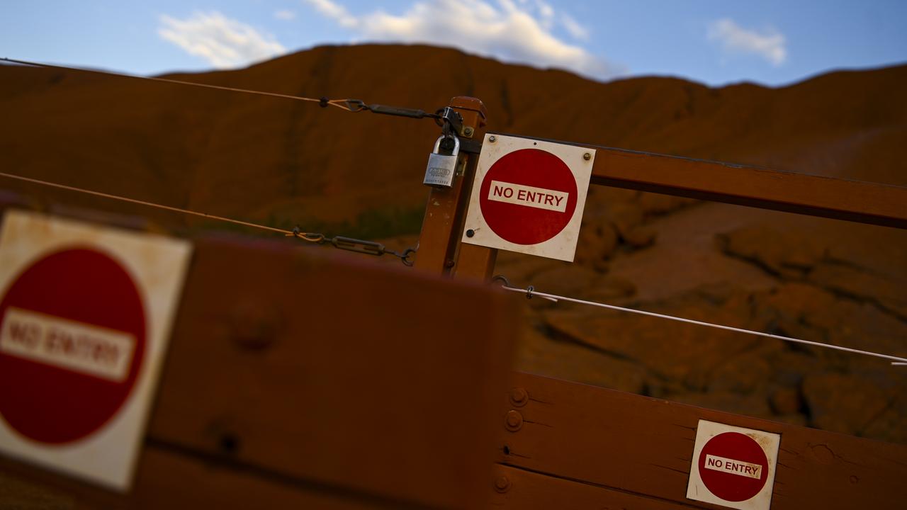 The locked gate to the climbing area at Uluru, which will be closed to climbers from Saturday. Picture: Lukas Coch/AAP