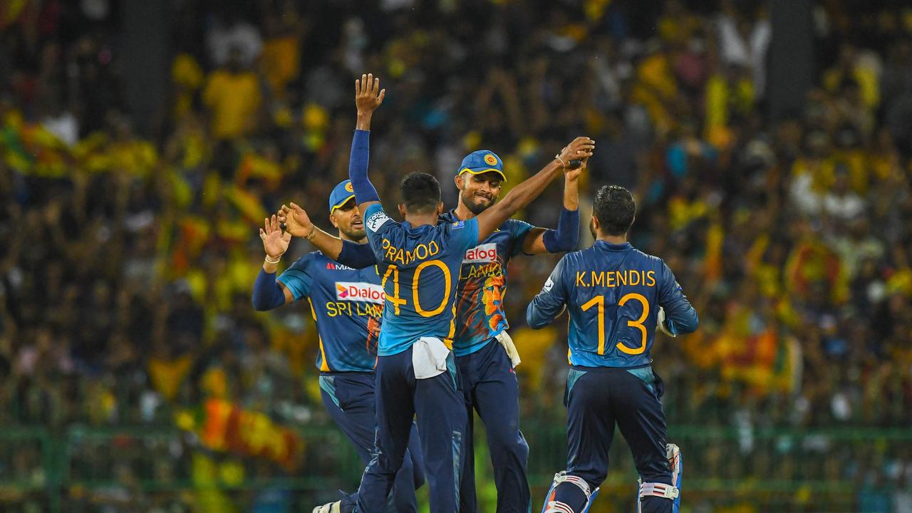 Sri Lanka's Pramod Liyanagamage celebrates with teammates. Photo by ISHARA S. KODIKARA / AFP)