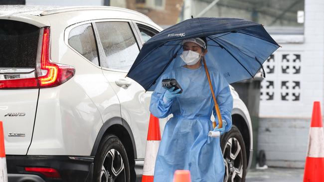 Health professionals are seen working at the Haberfield Drive through Covid-19 testing clinic as testing demand surges ahead of the holidays in Sydney. Picture: NCA NewsWire / Gaye Gerard.